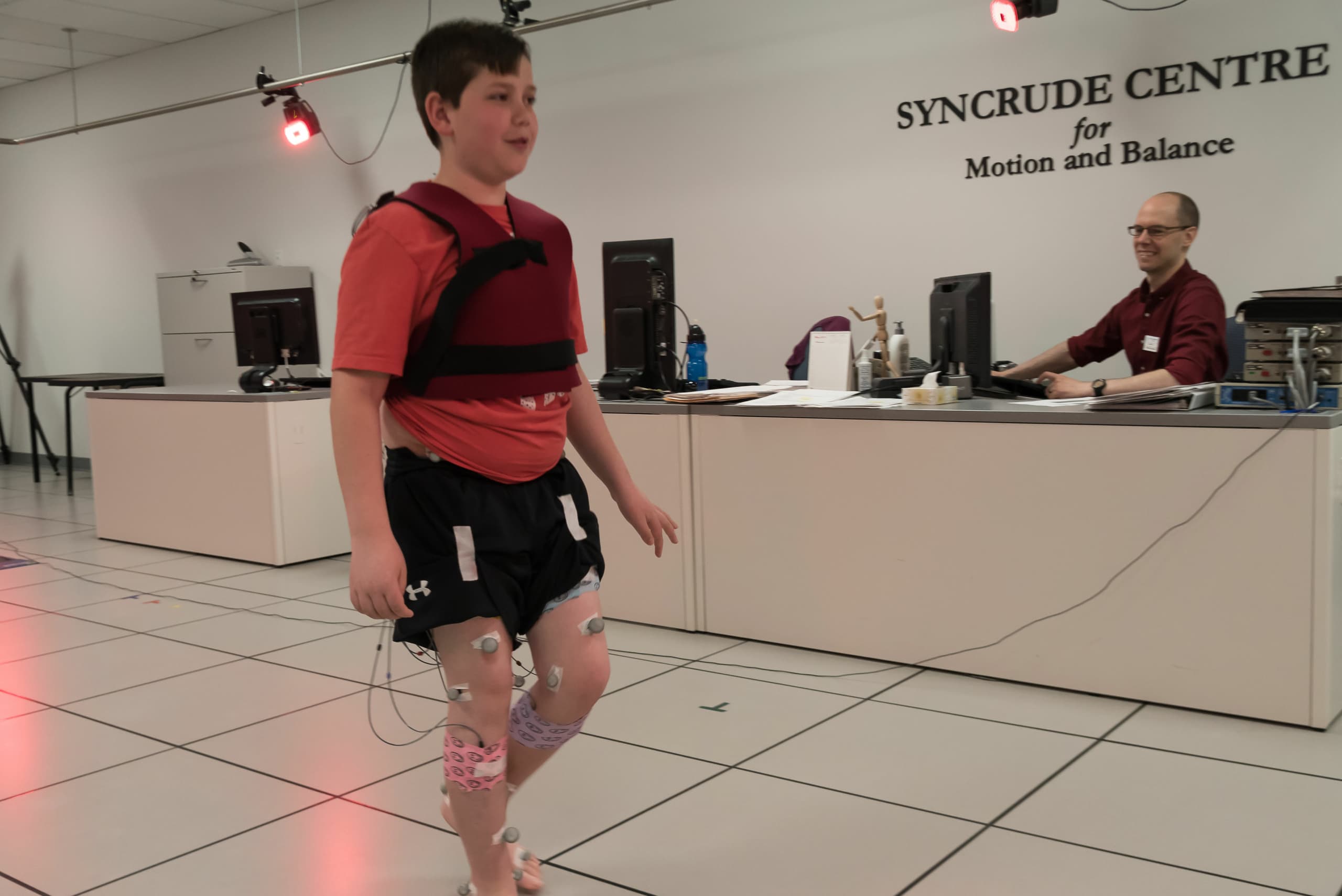Child with gate sensors attached in Syncrude Centre for Motion and Balance.