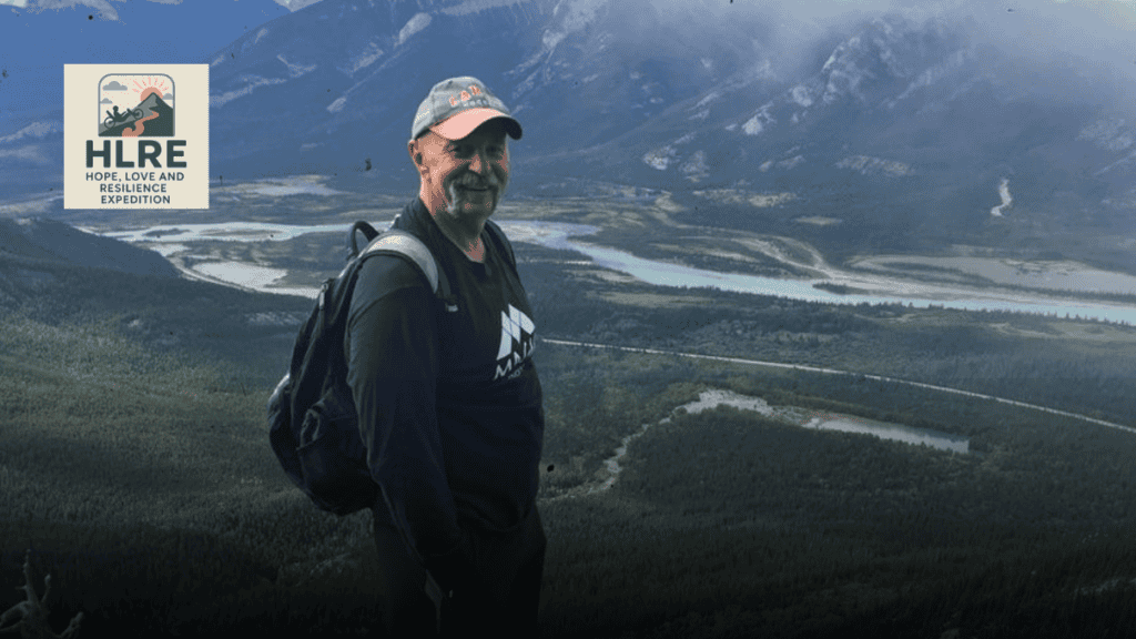 Mark Ivancic of the Hope, Love, and Resilience Expedition smiles for a photo in the mountains