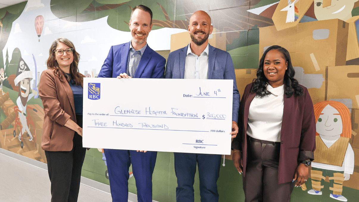A healthcare professionals presenting a donation check at Glenrose Hospital Foundation event.