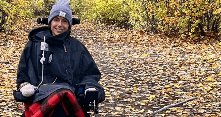 Chantelle smiling outdoors on a fall day in wheelchair